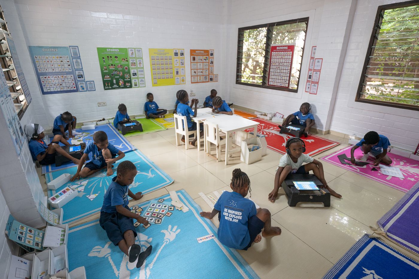 Children learning across colour-coded stations in a Leap Lab, The Gambia